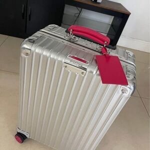 RIMOWA Silver Luggage with Bold Pink Accents
